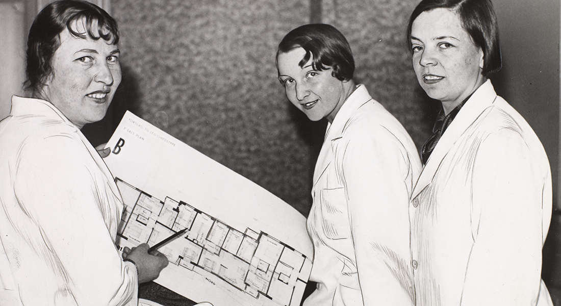 Three women looking at a plan drawing